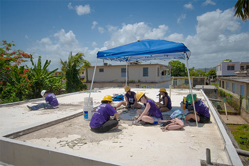Students mending a roof