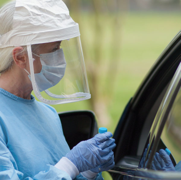 Nurse administering a test from a car window