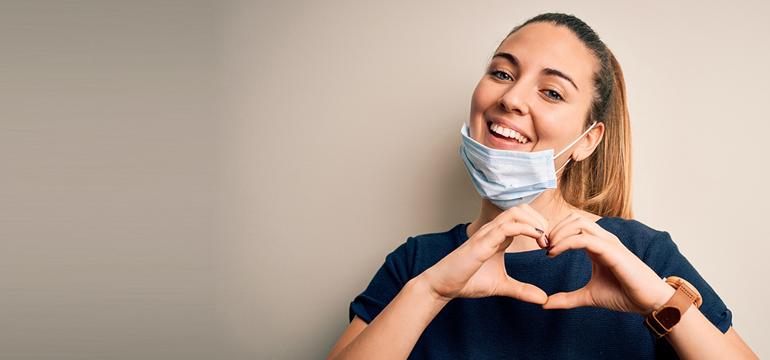 Nurse making a heart shape with her hands