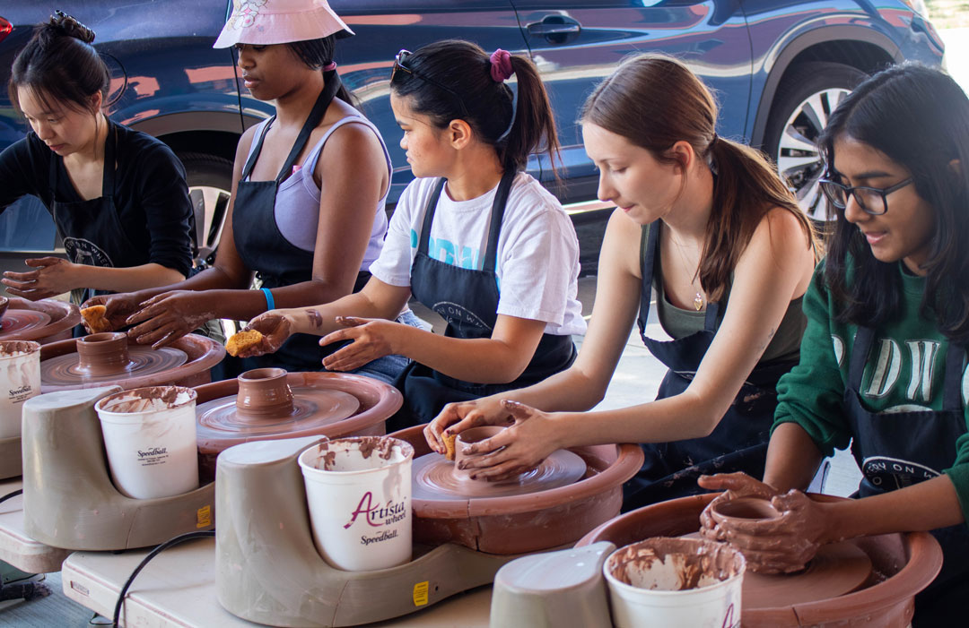 Group of students partaking in a pottery event