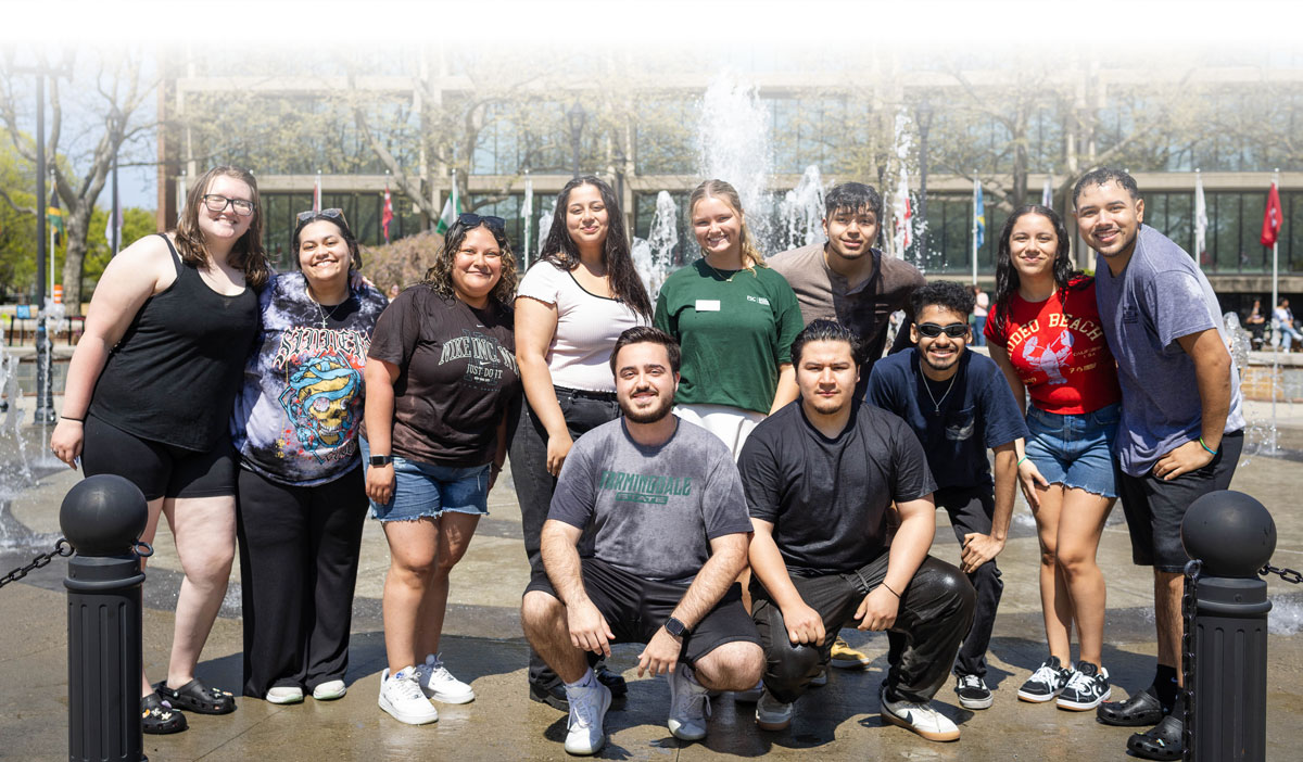 Group of students in front of the Bunche Plaza fountain after running through the water