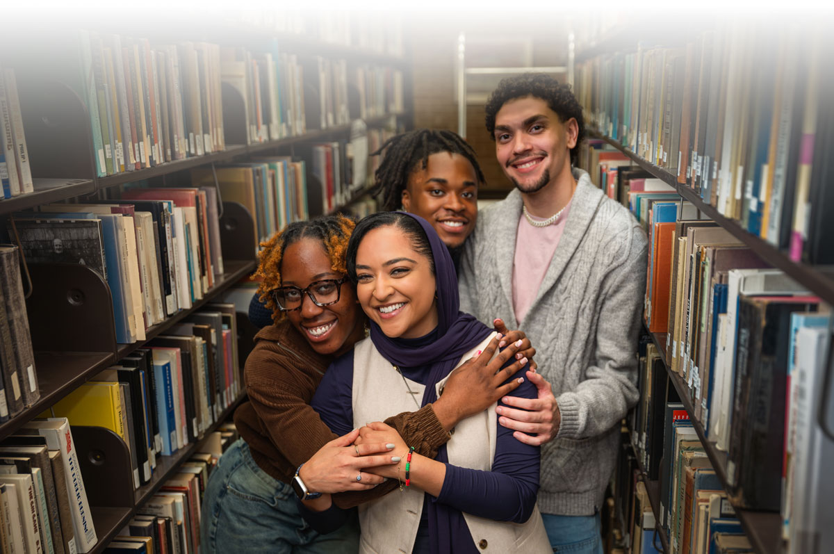 Fatoma Rad, associate librarian with a group of students and faculty / staff members in the library
