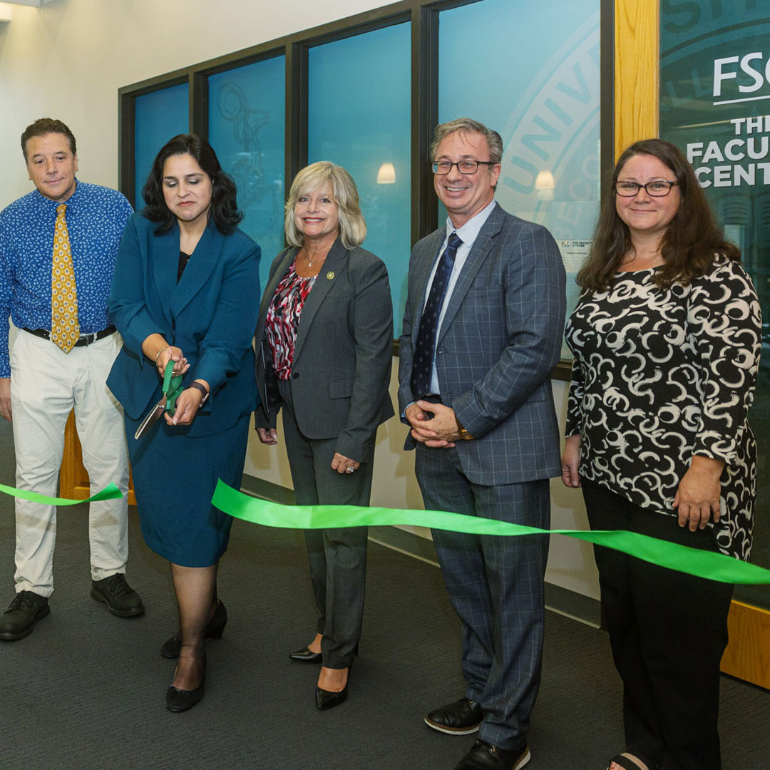 Dr. Laura Joseph cutting ribbon for the faculty center.
