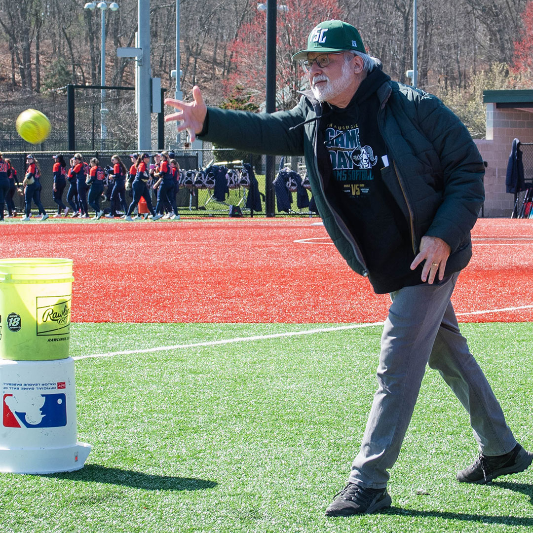 President Dr. Prezant throwing first pitch at the FSC women's softball game